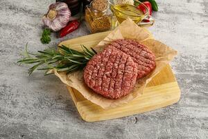 Raw burger cutlet for grill photo