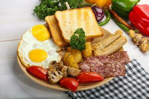 English breakfast with toast, egg and sausages photo