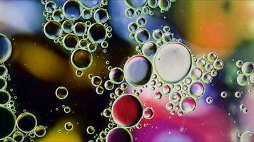 Abstract Colorful Food Oil Drops Bubbles and spheres Flowing on Water Surface photo