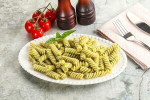 Italian pasta with basil pesto photo