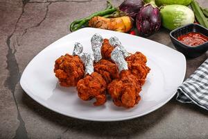 Indian cuisine glazed chicken lollipop photo