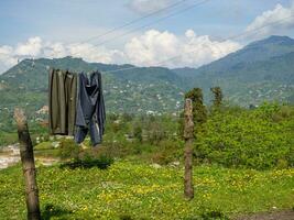 Things are dried on a rope in the mountains. Beautiful place.  Drying laundry in nature. photo