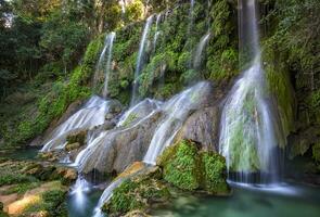 El Nicho Waterfalls in Cuba. El Nicho is located inside the Gran Parque Natural Topes de Collantes a forested park that extends across the Sierra Escambray mountain range in central Cuba. photo