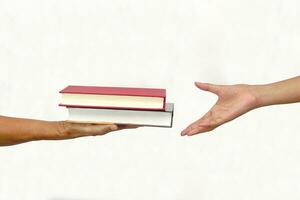 Two people exchanging books or sharing books on white background. exchanging knowledge and education concept. photo