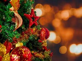 Close up of christmas tree with decorations, copy space area, and blur light background. photo