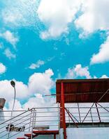 A blue sky with clouds and a street light photo