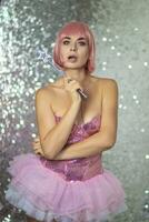 Woman in a short pink wig with a magic wand photo