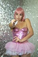 Woman in a short pink wig with a magic wand photo