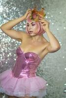 Woman in pink wig with gold crown. Halloween photo