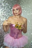 Woman in pink wig with gold crown. Halloween photo