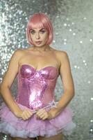 Woman in a short pink wig with a magic wand photo