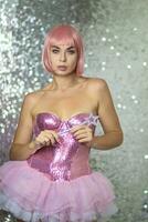 Woman in a short pink wig with a magic wand photo