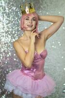 Woman in pink wig with gold crown. Halloween photo