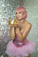 Woman in pink wig with gold crown. Halloween photo