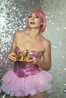 Woman in pink wig with gold crown. Halloween photo