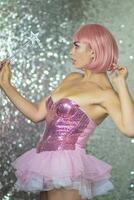 Woman in a short pink wig with a magic wand photo