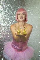 Woman in pink wig with gold crown. Halloween photo