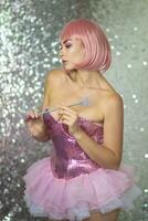 Woman in a short pink wig with a magic wand photo