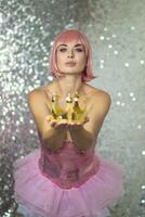 Woman in pink wig with gold crown. Halloween photo