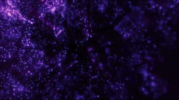 Blurred purple abstract background of bokeh and small round particles of energy magical holiday flying dots on a black background video