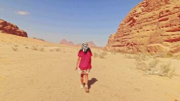 mujer turista excursionista a pie explorar wadi rum caminata por el desierto en vacaciones en wadi rum. popular desierto de wadi rum en jordania video