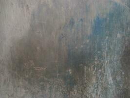 Weathered concrete wall. Grunge blue and grey wall background. Damaged cement surface. Aged wall building. photo