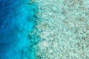 Shades of blue. Beautiful coral reef in Maldives island, aerial landscape, shallow sea water as lagoon. Amazing exotic nature texture underwater and ocean surface. photo