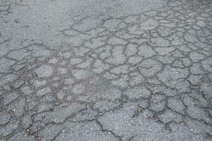 Asphalt pavement that has been cracked from use over a period of time photo