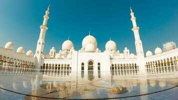 Abu dhabi, UAE, 2022 - Grand Mosque in Abu Dhabi mid day in hot weather. Wide low angle panorama of exterior of Sheikh Zayed Mosque photo