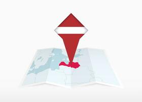 Letonia es representado en un doblada papel mapa y clavado ubicación marcador con bandera de letonia vector
