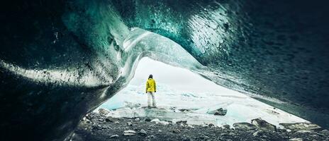 Panoramic viewpoint tourist by Fjallsjokull glacier in Iceland from inside glacier cave. Explore sightseeing Iceland spectacular hidden gems. Traveler hands up enjoy travel concept photo