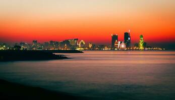 Stunning beautiful Batumi waterfront in Adjara, Georgia. Modern Architecture In Seafront Promenade In Night Or Evening Illuminations, Illuminated Resort Town Cityscape Skyscrapers photo