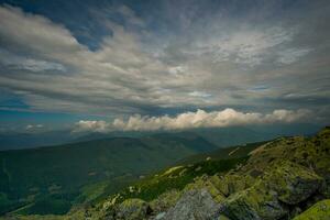 Beautiful clouds over mountains and rocks. View from the top of the mountain photo