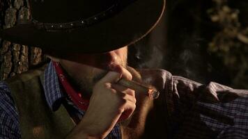 Cowboy with a cigar in the forest at night. Life in the wild west of America photo