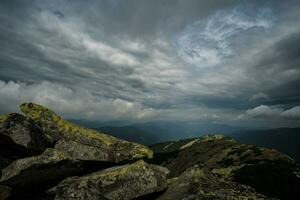 Beautiful clouds over mountains and rocks. View from the top of the mountain photo