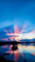 Sunset reflection and clouds in the reservoir photo