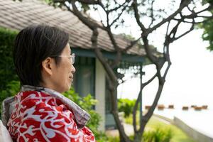 Senior Woman Siting Outdoor and Looking out at Nature View photo