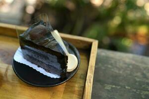 Chocolate cake in a wooden tray photo