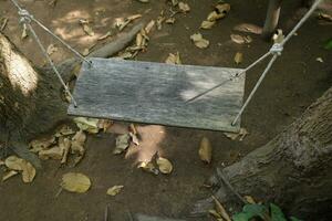 Wooden swing for sitting in the garden photo