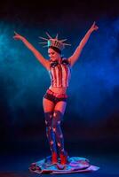 Young woman in stage costume of striptease dancer posing photo