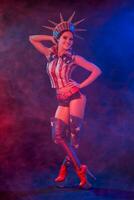 Young woman in stage costume of striptease dancer posing photo