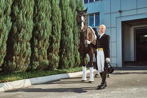 woman jockey with his horse photo