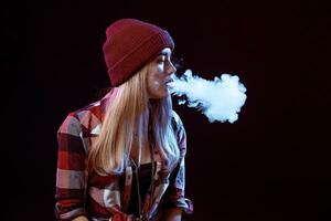 young woman smoking electronic cigarette photo