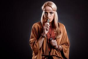 Young woman in the Boho style blowing smoke photo