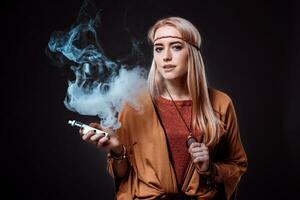 Young woman in the Boho style blowing smoke photo