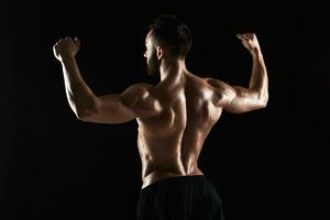 very muscular man posing with naked torso in studio photo