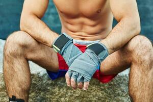 Close up of fit man wearing bandage on his hand photo