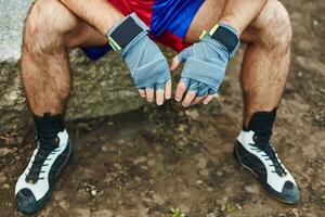 Close up of fit man wearing bandage on his hand photo