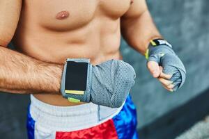 Close up of fit man wearing bandage on his hand photo