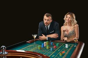 Couple playing roulette wins at the casino. photo